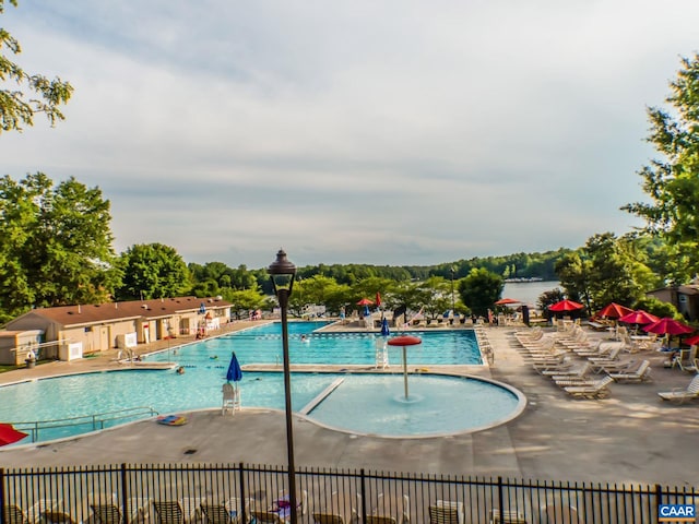 pool with fence and a patio