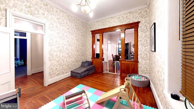 interior space featuring parquet floors, crown molding, baseboards, and wallpapered walls