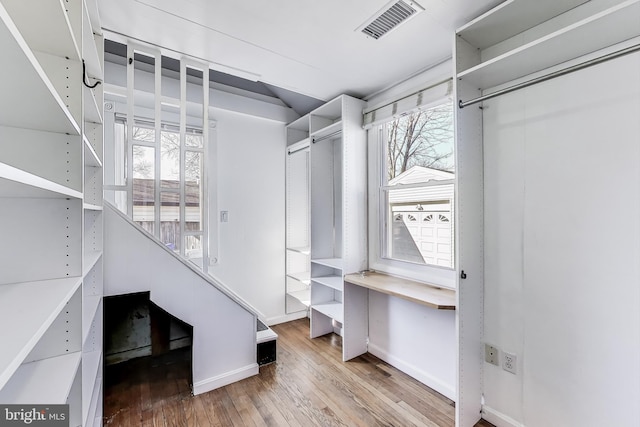 walk in closet featuring visible vents and wood finished floors