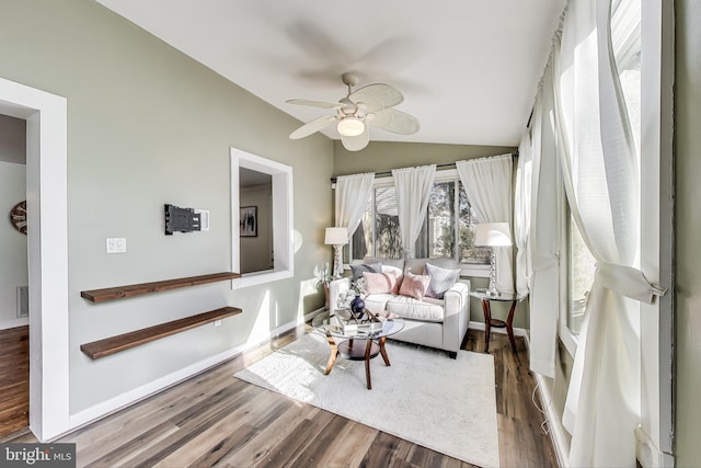 sunroom with ceiling fan, visible vents, and vaulted ceiling