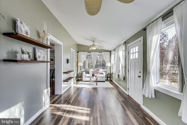 unfurnished sunroom with a ceiling fan and lofted ceiling