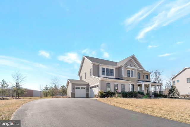 view of front of property featuring a garage, driveway, and a front lawn