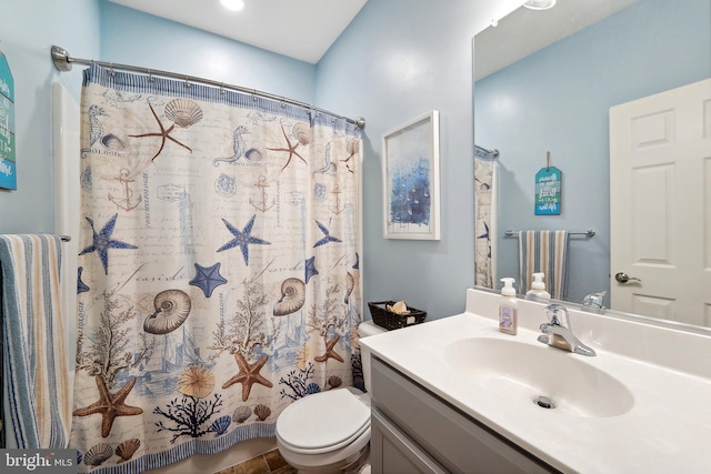 full bath featuring toilet, a shower with shower curtain, and vanity