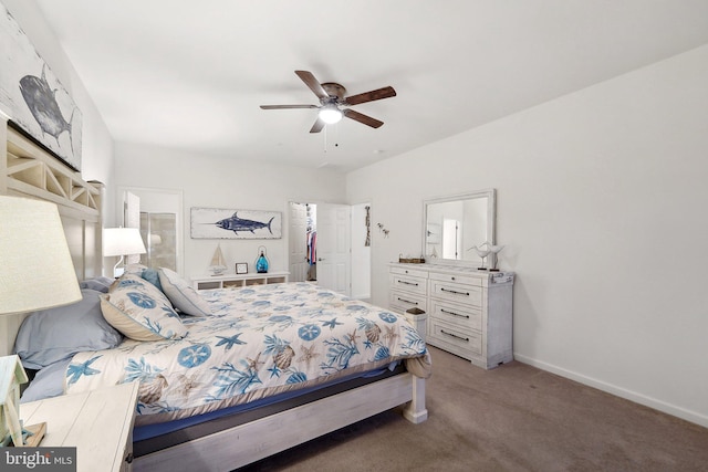 carpeted bedroom with ceiling fan, ensuite bath, and baseboards