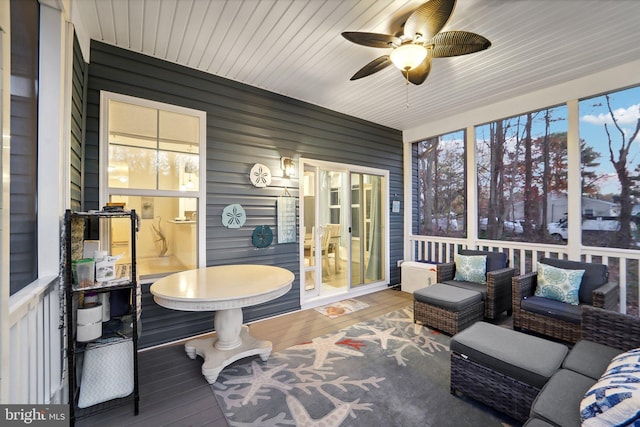 sunroom featuring ceiling fan