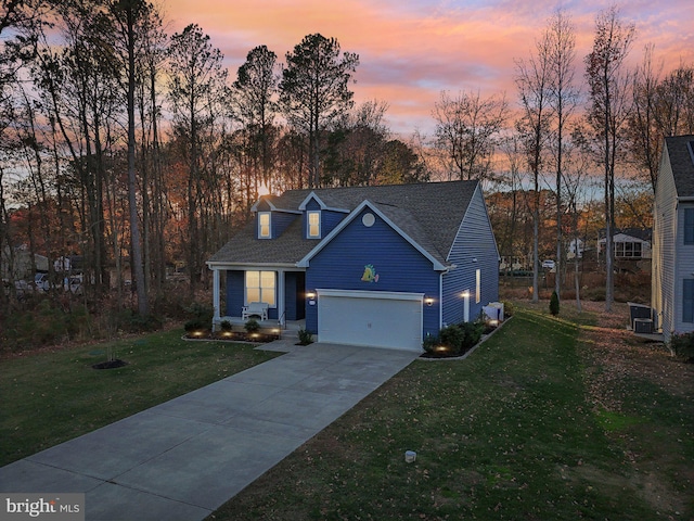 traditional home with driveway, a garage, and a front lawn