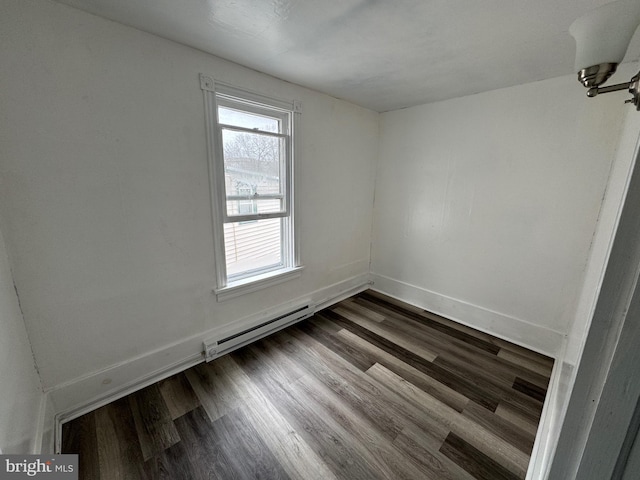 unfurnished room with baseboards, baseboard heating, and wood finished floors