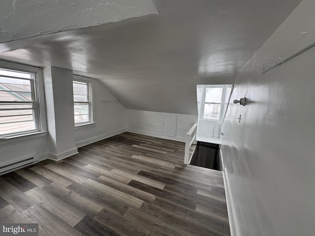 bonus room with lofted ceiling, a baseboard radiator, baseboards, and dark wood finished floors