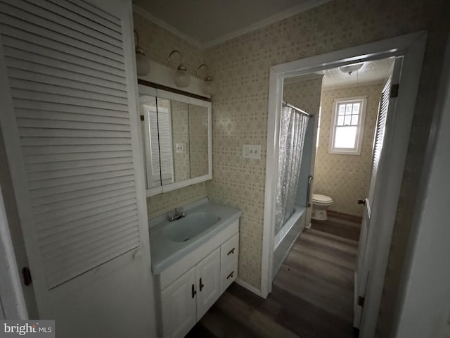 bathroom featuring ornamental molding, a stall shower, vanity, wood finished floors, and wallpapered walls