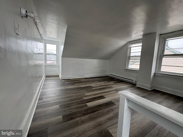 bonus room featuring baseboards, baseboard heating, and dark wood-style flooring