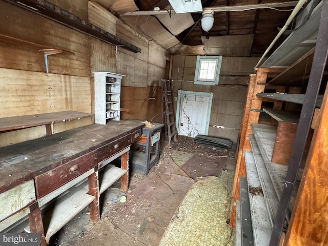 miscellaneous room featuring vaulted ceiling and a workshop area