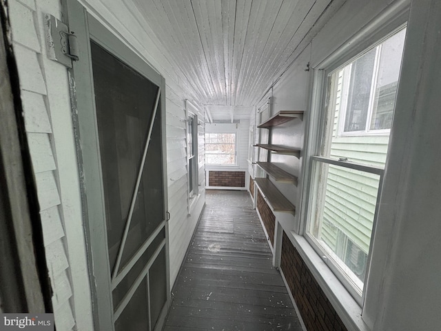 hall with dark wood-style flooring and wood ceiling