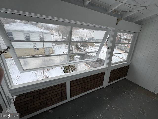 room details featuring concrete flooring and wooden walls