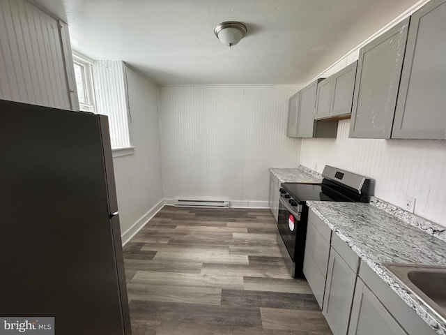 kitchen featuring a baseboard radiator, appliances with stainless steel finishes, dark wood-type flooring, light stone countertops, and gray cabinets