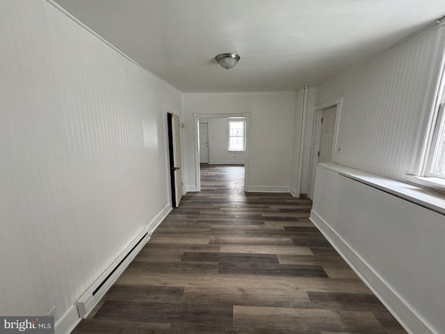 hall with dark wood-type flooring, baseboards, and baseboard heating