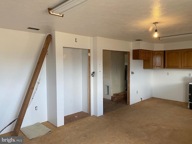 interior space featuring visible vents and brown cabinets