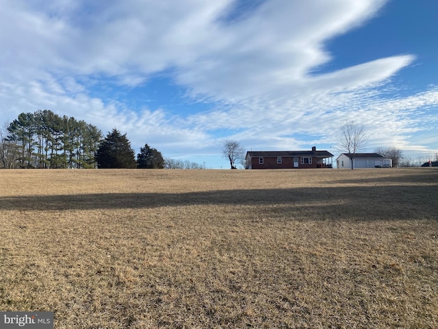 view of yard with a rural view