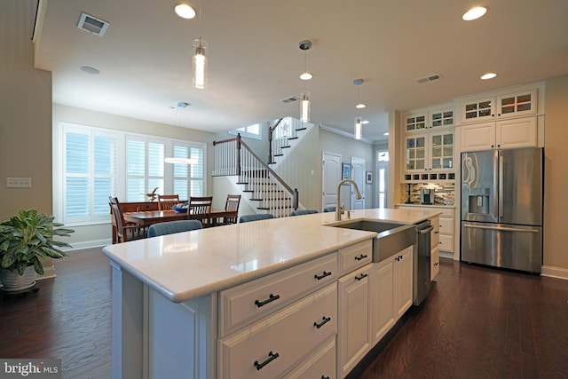 kitchen featuring light countertops, appliances with stainless steel finishes, glass insert cabinets, and white cabinetry