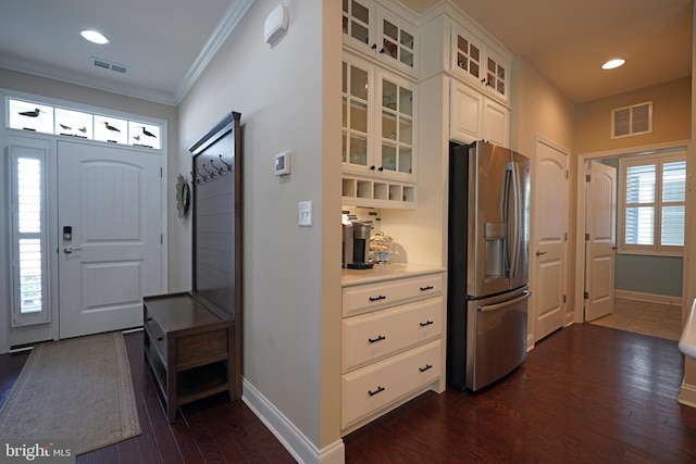 interior space with dark wood-style floors, baseboards, visible vents, and crown molding