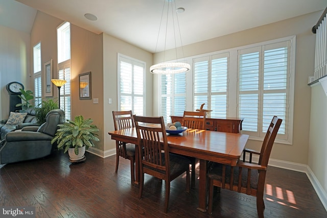 dining space featuring dark wood finished floors and baseboards