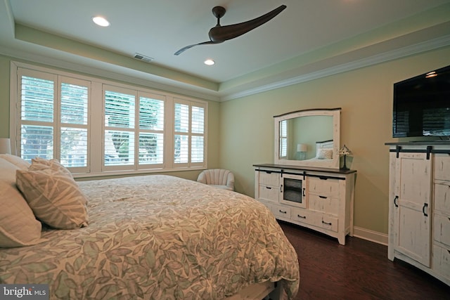 bedroom featuring dark wood-style floors, visible vents, a raised ceiling, and recessed lighting