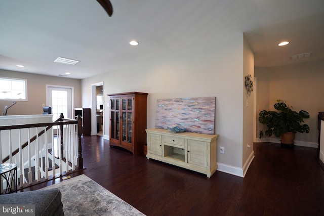 living room with dark wood-style floors, recessed lighting, visible vents, and baseboards