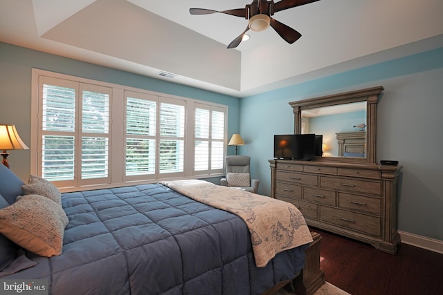 bedroom featuring ceiling fan, baseboards, visible vents, and dark wood finished floors