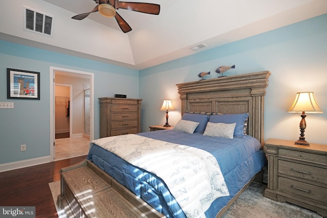 bedroom with a ceiling fan, baseboards, visible vents, and wood finished floors