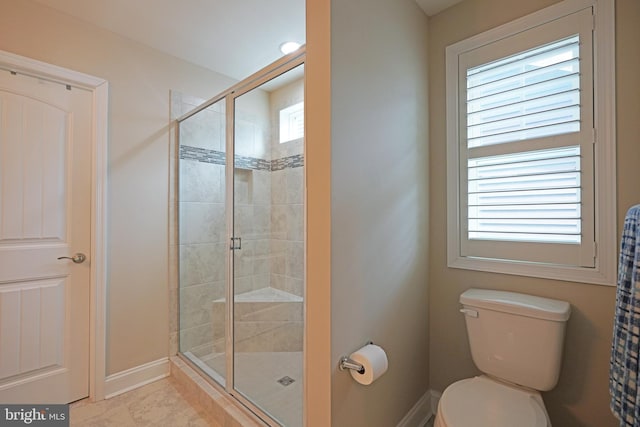 full bath featuring a stall shower, baseboards, a healthy amount of sunlight, and toilet