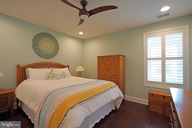 bedroom with baseboards, multiple windows, visible vents, and dark wood-type flooring