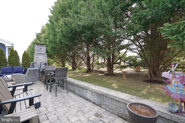 view of patio / terrace featuring an outdoor living space with a fireplace