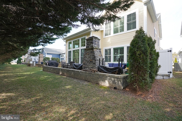 view of home's exterior featuring stone siding and a lawn