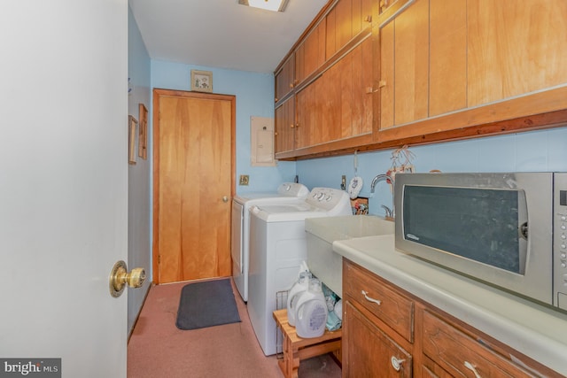 laundry area featuring separate washer and dryer and cabinet space