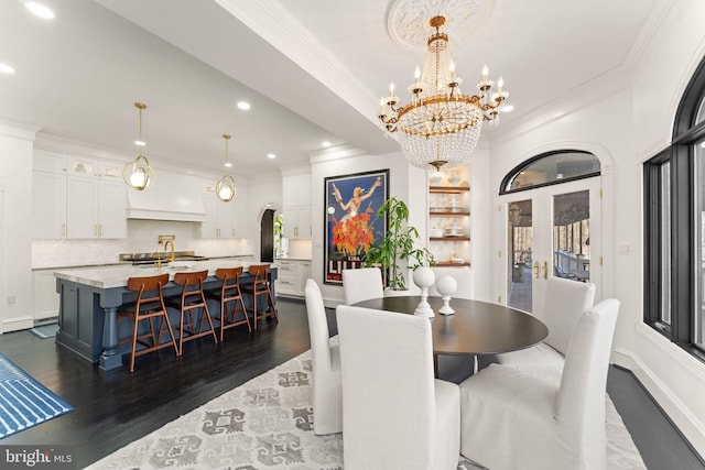 dining space with arched walkways, recessed lighting, dark wood finished floors, and crown molding