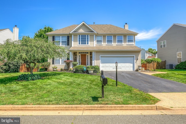 view of front of house with aphalt driveway, a chimney, an attached garage, fence, and a front lawn