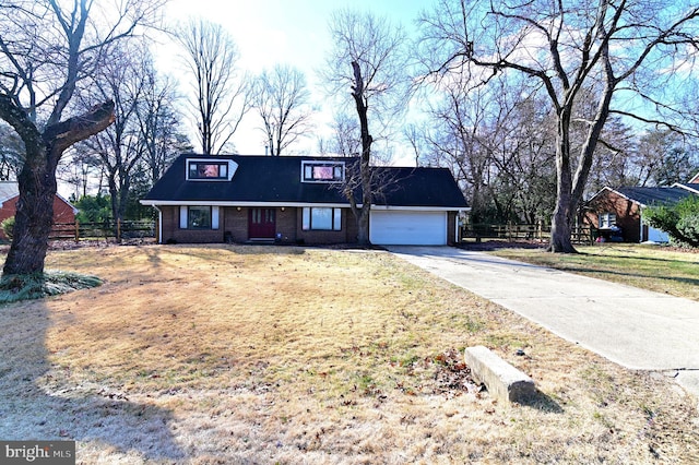 view of front facade with a garage, brick siding, fence, concrete driveway, and a front yard