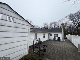 view of side of property featuring fence