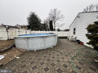 view of swimming pool with a fenced in pool and fence