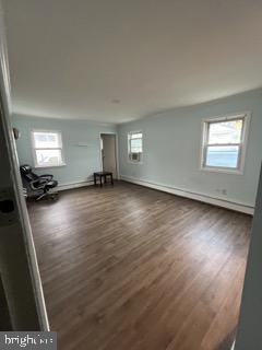 unfurnished room featuring dark wood finished floors and a wealth of natural light