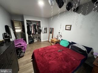 bedroom featuring a closet and light wood finished floors