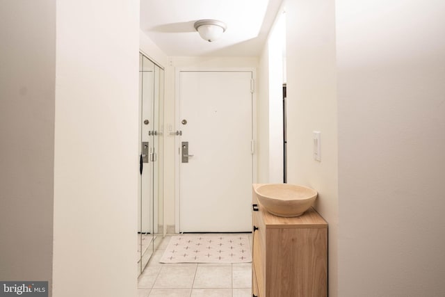 doorway with light tile patterned flooring