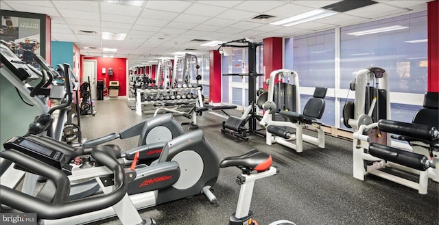 workout area with visible vents and a paneled ceiling