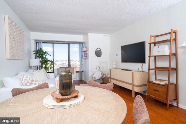 bedroom with a textured ceiling and wood finished floors