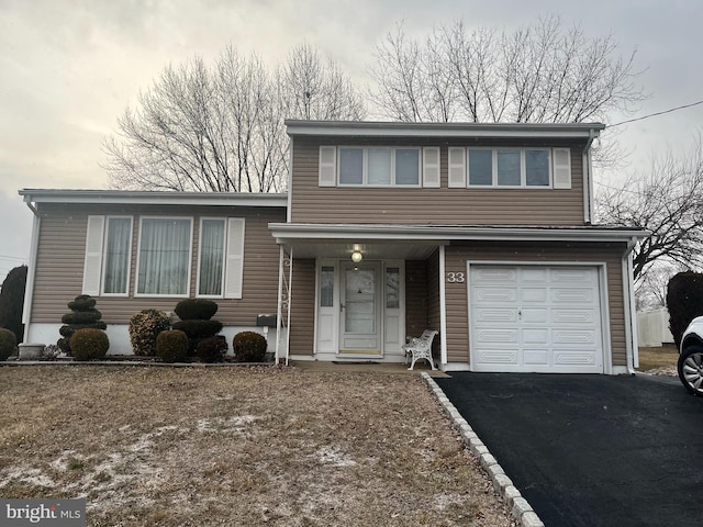 tri-level home featuring a garage and driveway