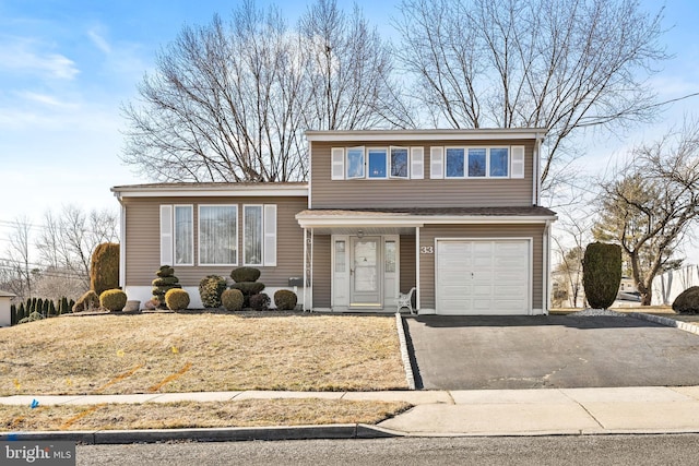 tri-level home with an attached garage and aphalt driveway