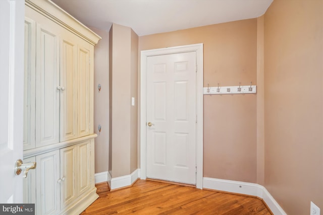 entryway featuring baseboards and light wood finished floors