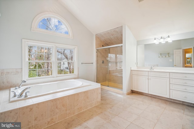 bathroom featuring a garden tub, a shower stall, tile patterned floors, and vanity