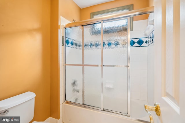 bathroom with toilet and enclosed tub / shower combo