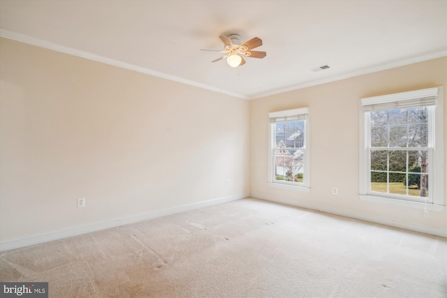 spare room featuring visible vents, baseboards, ceiling fan, ornamental molding, and carpet