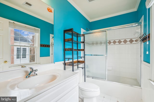 full bathroom with toilet, shower / bath combination with glass door, vanity, visible vents, and crown molding